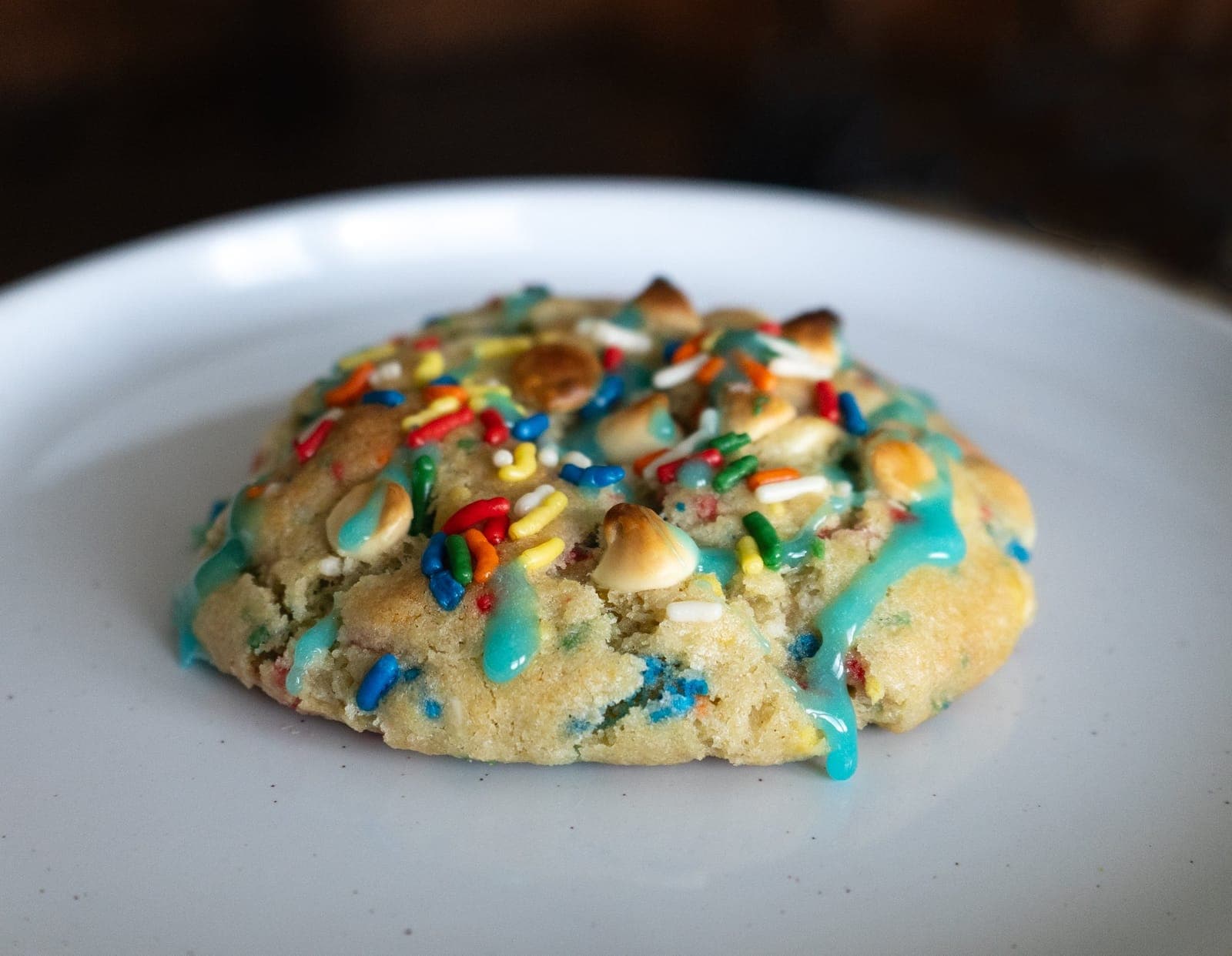 Large birthday cake cookie with rainbow sprinkles and blue drizzle