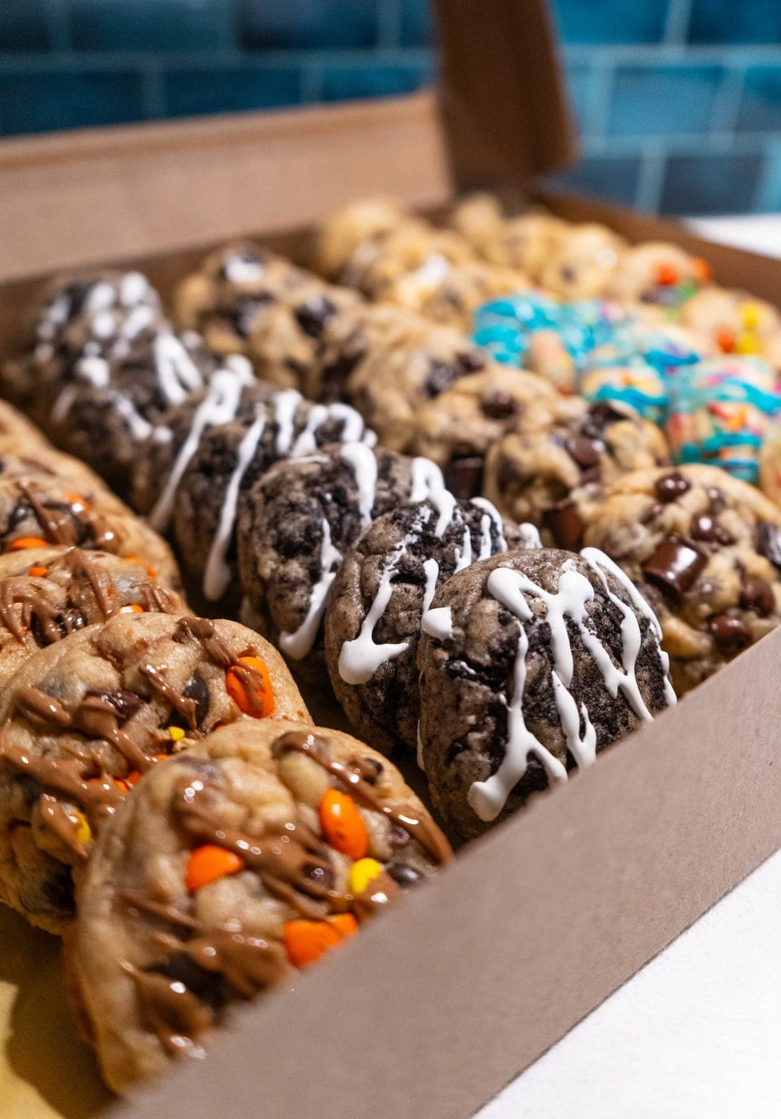 Open kraft box packed with assorted mini cookies