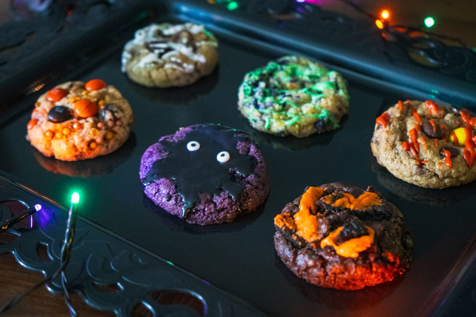 Close-up of Halloween cookies, with the purple Ube Monster cookie in front